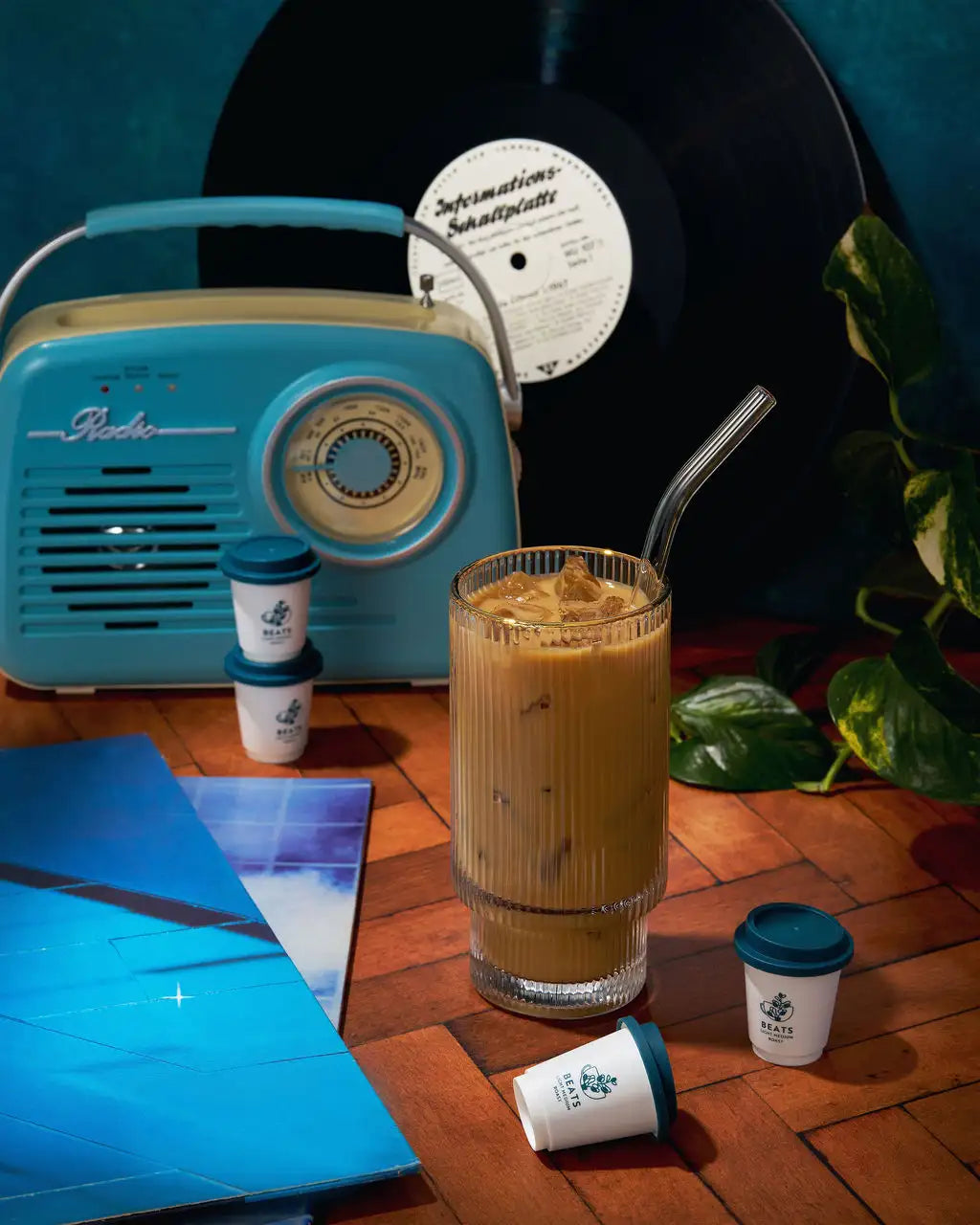 Retro scene with blue radio, vinyl, and iced coffee | Cozy Indigo Coffee