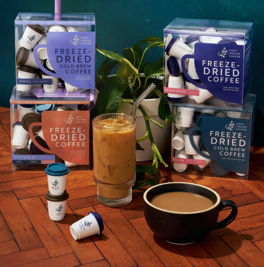Freeze-dried coffee pods with iced coffee and plant | Cozy Indigo Coffee