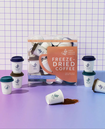 Coffee pods on purple gradient with grounds | Cozy Indigo Coffee
